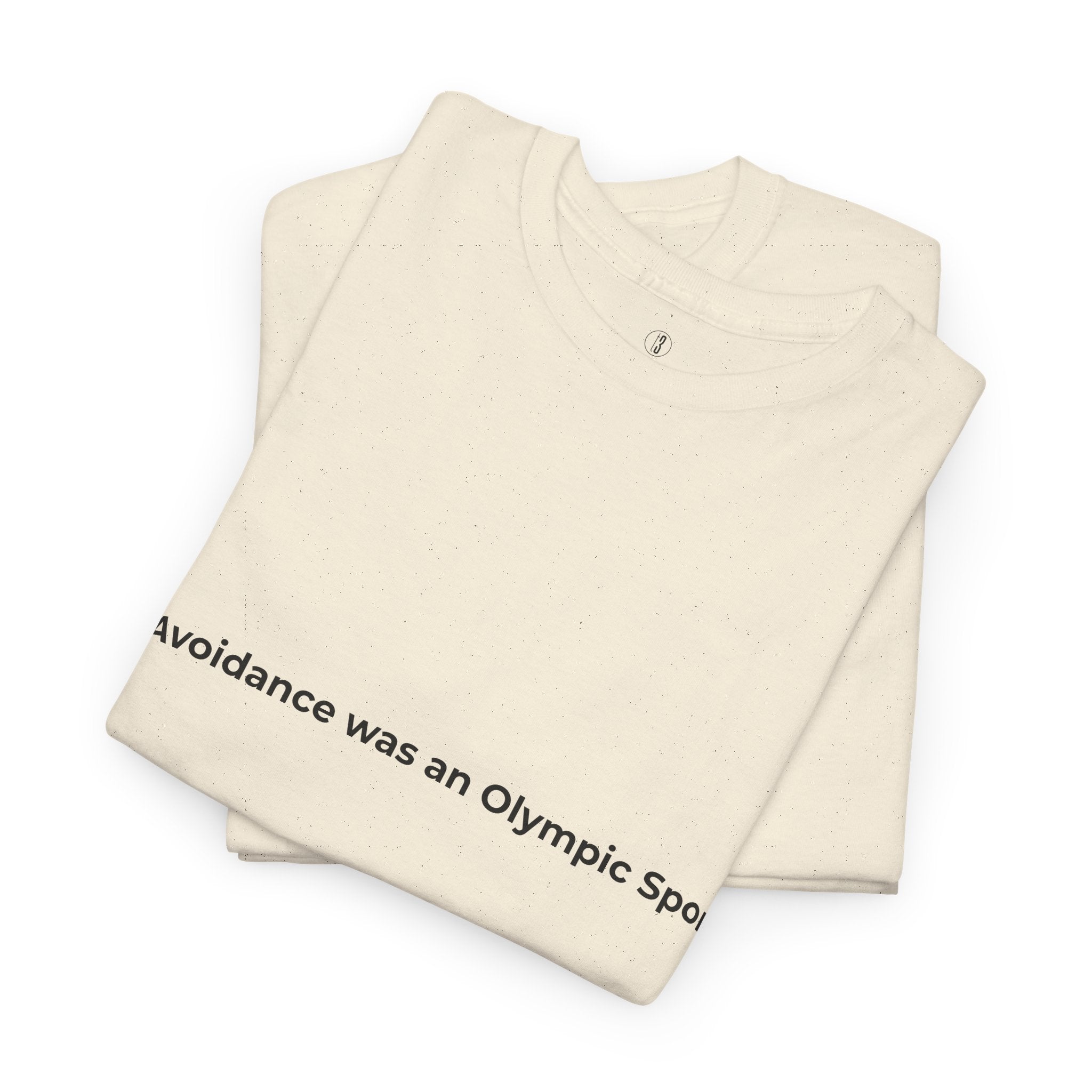 Beige t-shirt with text 'Avoidance was an Olympic Sport' on a white background