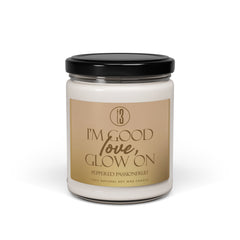 “I’m Good, Love, Glow On” aromatherapy candle from T3 Wellness, shown in three views: lit with a moody background, and unlit with lid on and off. Housed in a glass jar with a beige label and black text, this hand-poured candle features a citrus-forward fragrance blend of juicy orange, melon, pineapple, jasmine, and passionfruit. Designed for emotional grounding, relaxation, and self-care rituals. Available now at teatimewithtoniya.com.