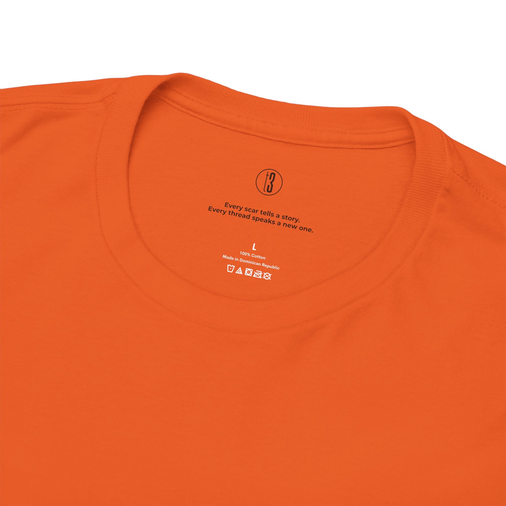 Close-up of an orange t-shirt with text and branding on a white background