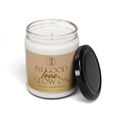 “I’m Good, Love, Glow On” aromatherapy candle from T3 Wellness, shown in three views: lit with a moody background, and unlit with lid on and off. Housed in a glass jar with a beige label and black text, this hand-poured candle features a citrus-forward fragrance blend of juicy orange, melon, pineapple, jasmine, and passionfruit. Designed for emotional grounding, relaxation, and self-care rituals. Available now at teatimewithtoniya.com.